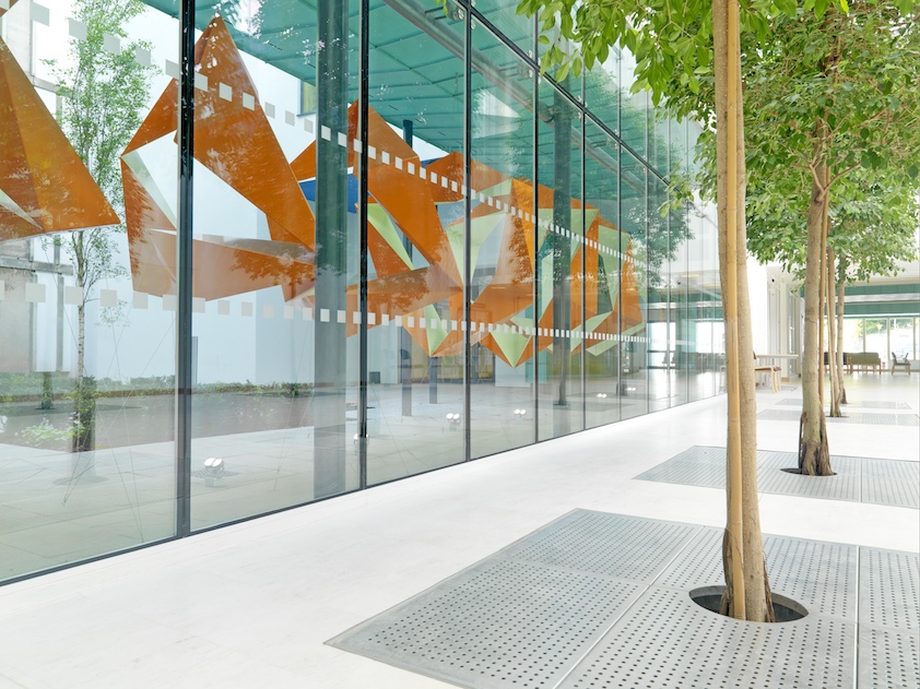 Modern glass fronted building with natural shading from nearby trees Stretto Architects